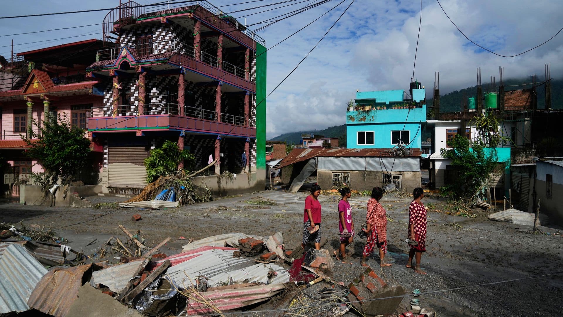Personas caminan por la zona dañada luego de la riada en Nepal, el 27 de agosto 2026