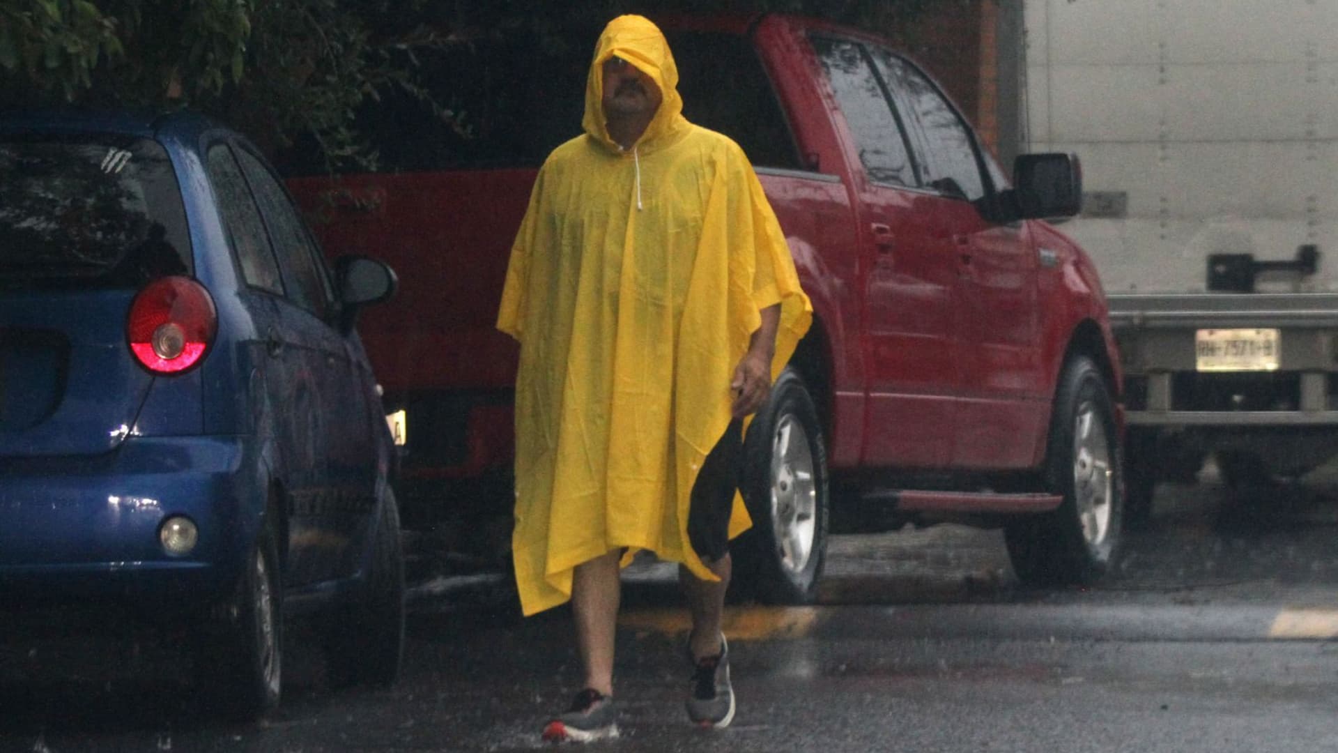 Un hombre usa un impermeable durante una fuerte lluvia en Monterrey, Nuevo León