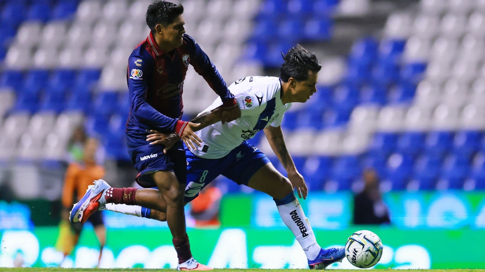 El camotero Omar Fernando Moreno Villegas disputa una pelota con el atlantista Walter Portales.