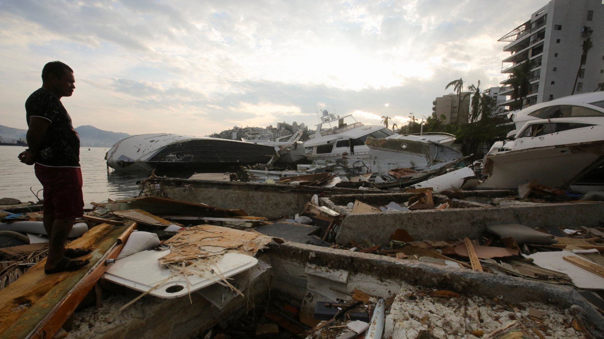 Un hombre observa los daños en lanchas por el paso del huracán Otis el 11 de noviembre.