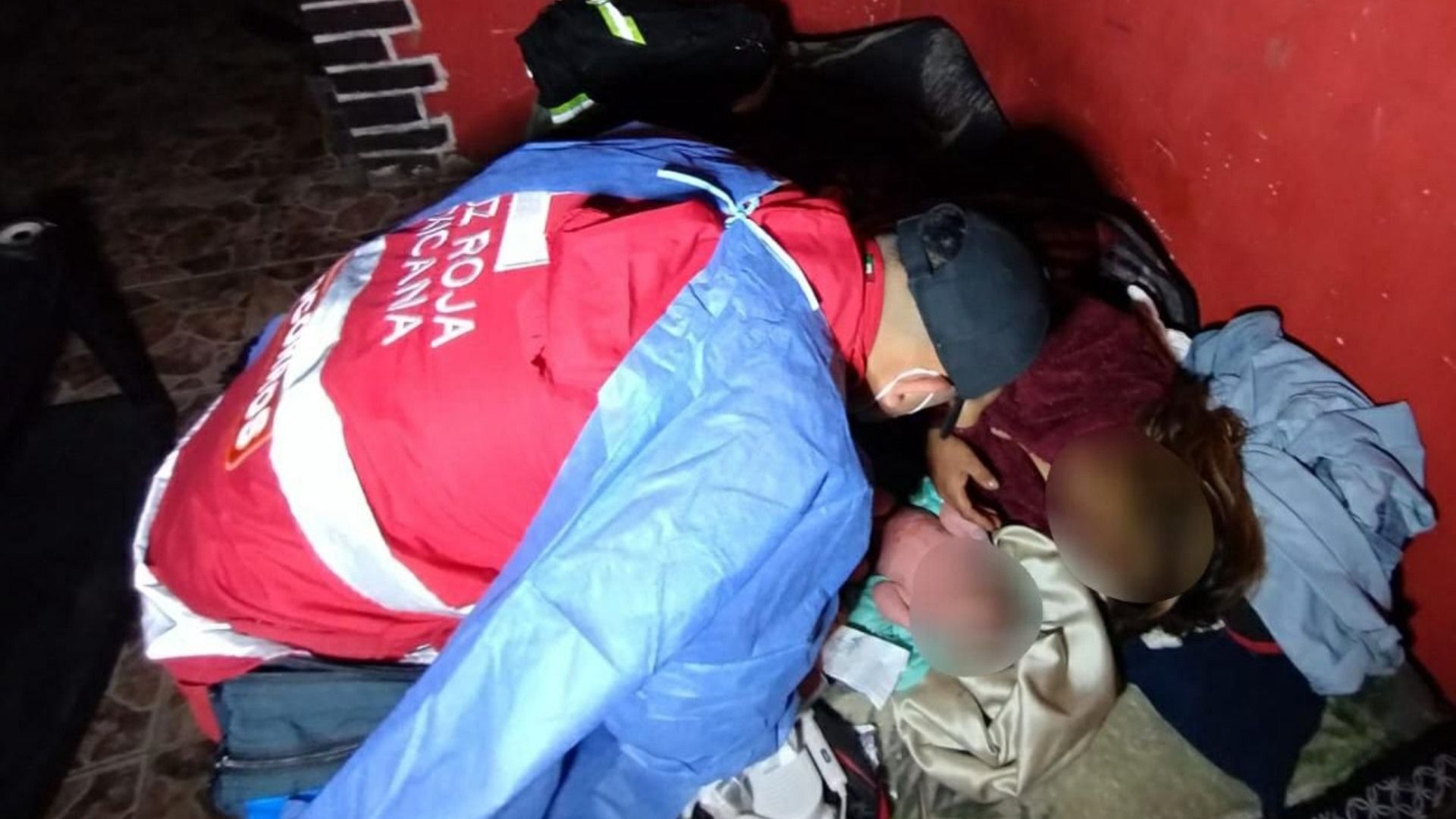 Paramédico de la Cruz Roja auxilia a madre en labor de parto. 